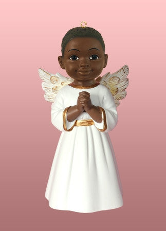 Christ child Jesus figurine in angel hair on fir branch over black
